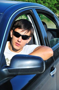 Man with sunglasses driving a car